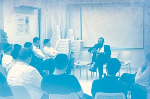 שיעור בבית המדרש — הרב מושיע מול קהל של סטודנטים