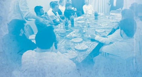 ארוחת ערב משותפת סביב שולחן ערוך בבית המדרש